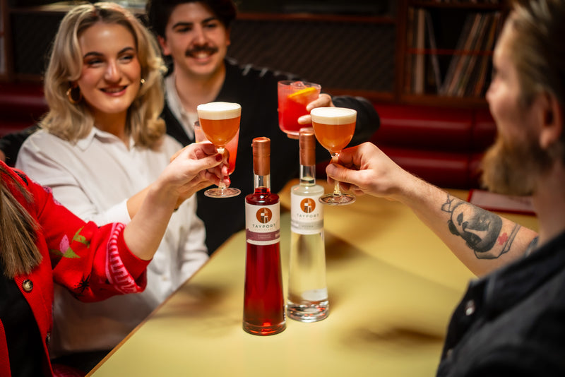 Three people enjoying a french martini at the table with Tayport Distillery Raspberry Liqueur and Malt Barley Vodka