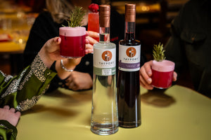 Group of people drinking a gin sour cocktail round a table with Tayport Distillery Blackcurrant Liqueur and Scots Pine Gin