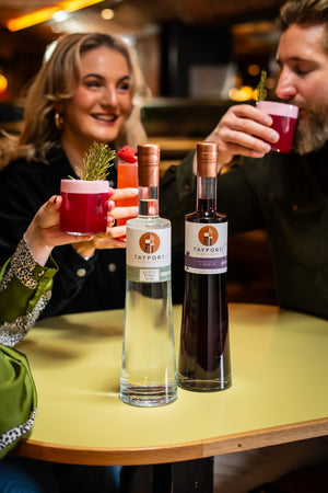 Group of people drinking a gin sour cocktail round a table using Tayport Distillery Blackcurrant Liqueur and Scots Pine Gin